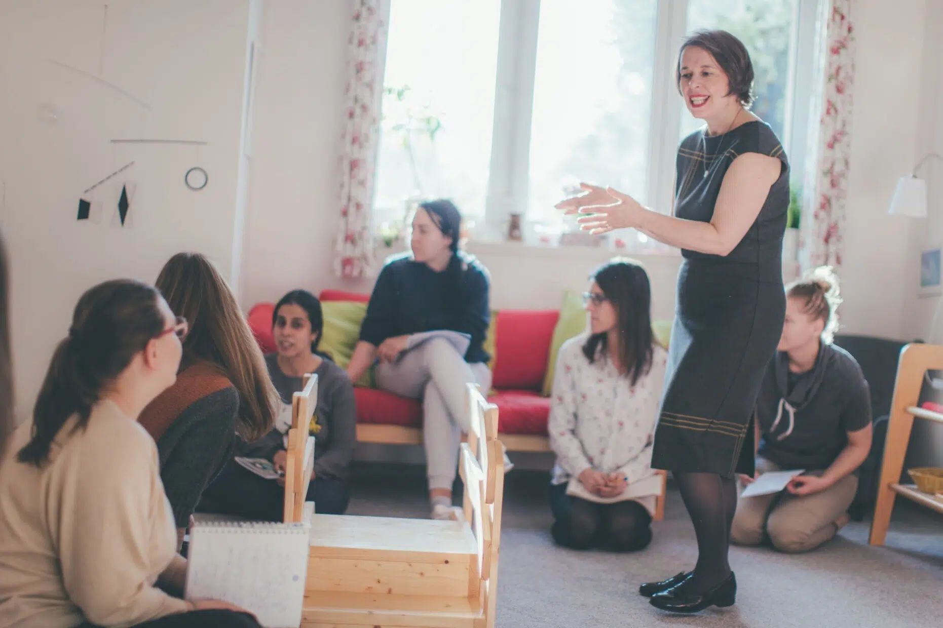 An AMI trainer working with a group of course participants at Montessori Institute Prague