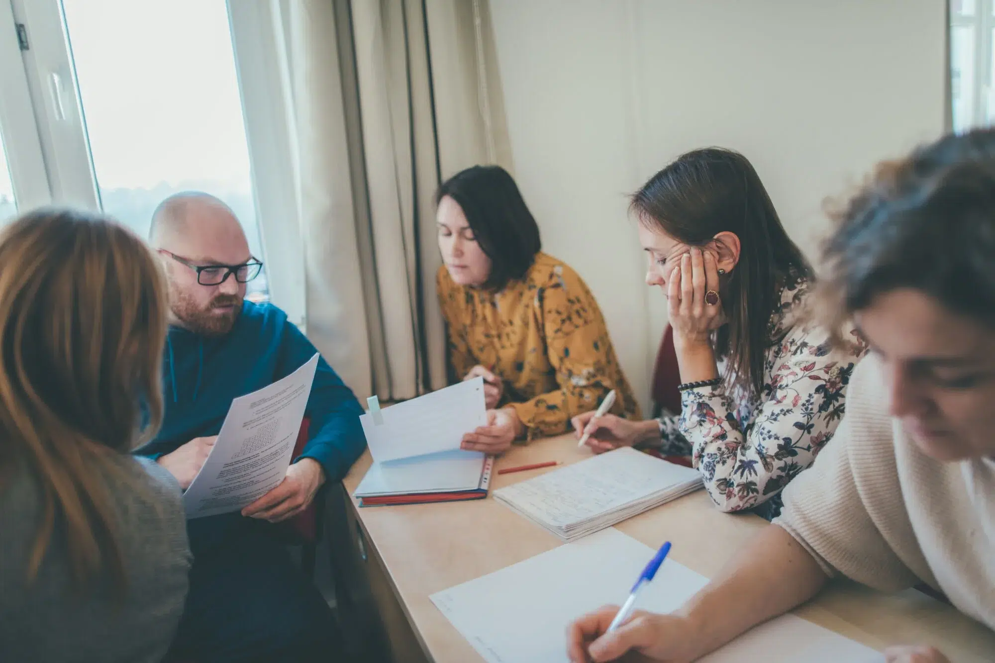 Course participants working together around a table at Montessori Institute Prague