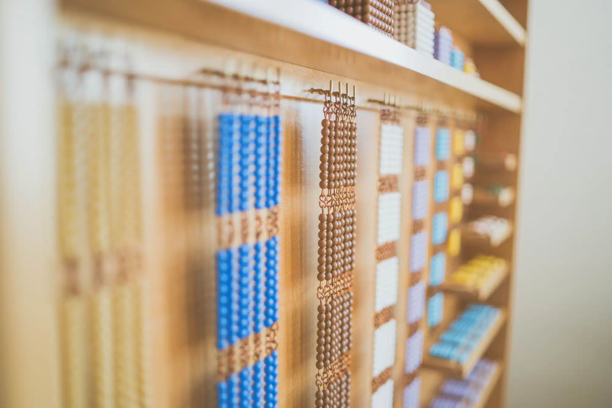 Montessori materials prepared on a shelf in a Children's House classroom